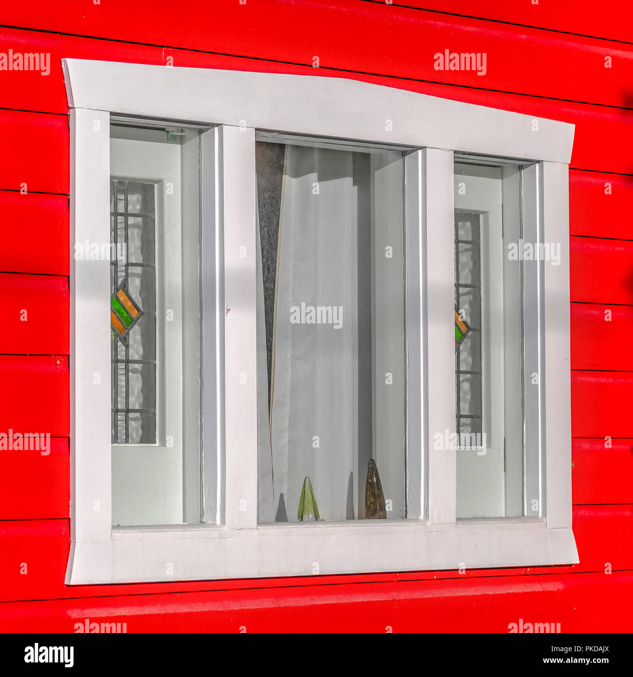 Bright red wall and window in the late day Stock Photo - Alamy