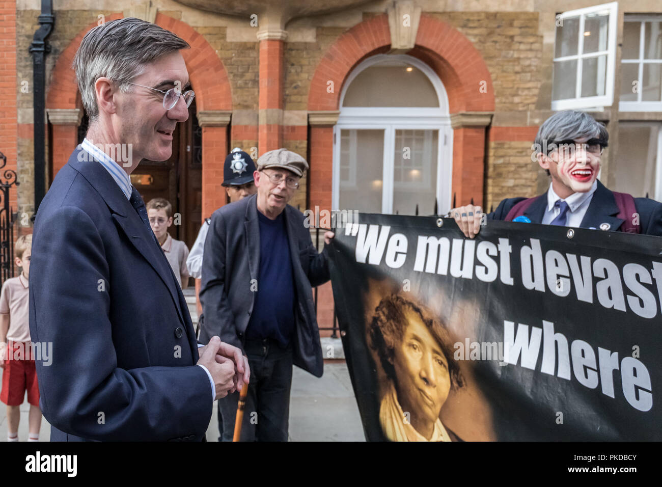 Jacob Rees-Mogg and his family are confronted by anti-capitalist protesters from Class War activist group outside his Westminster home. London, UK. Stock Photo