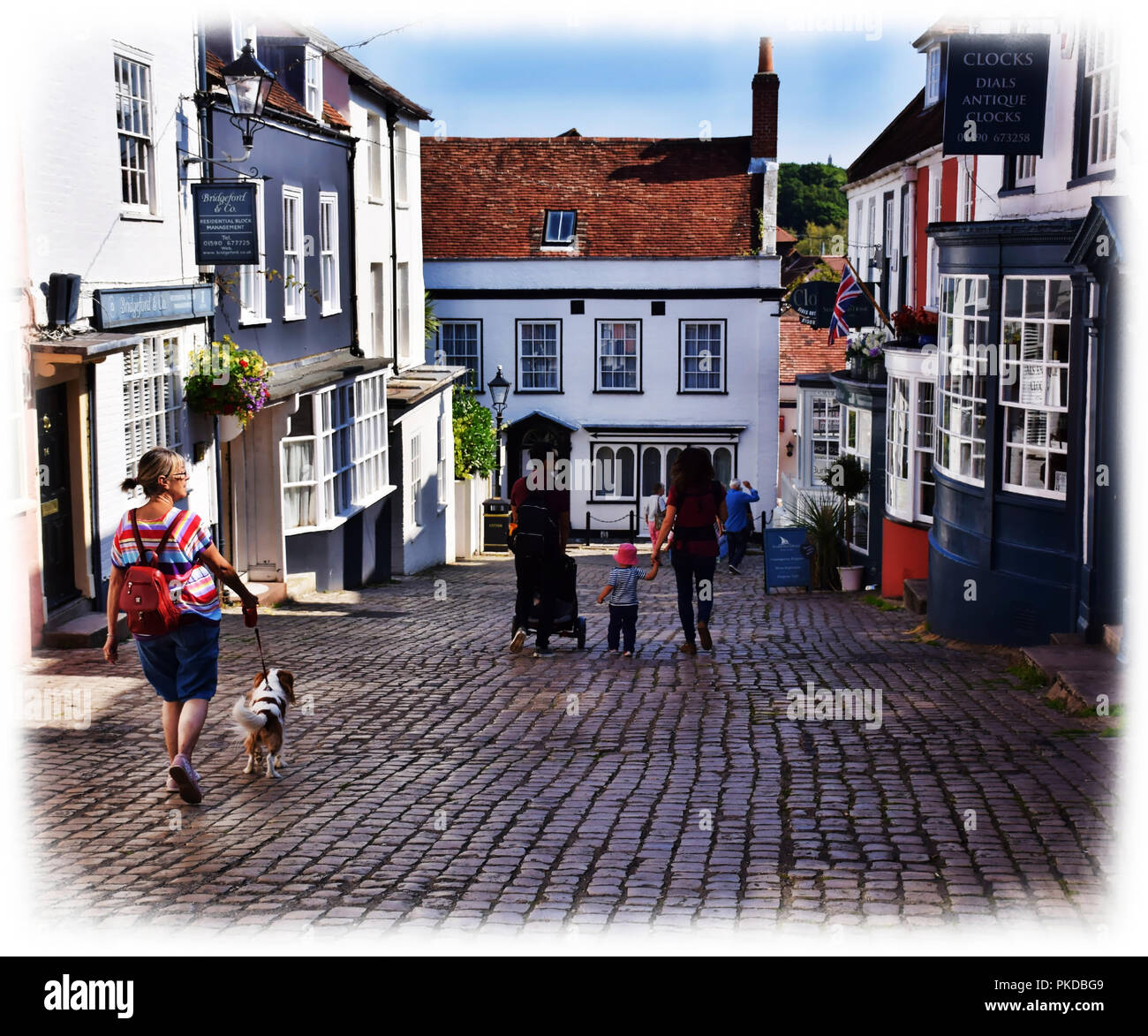 A cobbled street in the sailing town of Lymington, leads down to the busy quayside where people can fish, sail, catch the ferry or just chill. Stock Photo