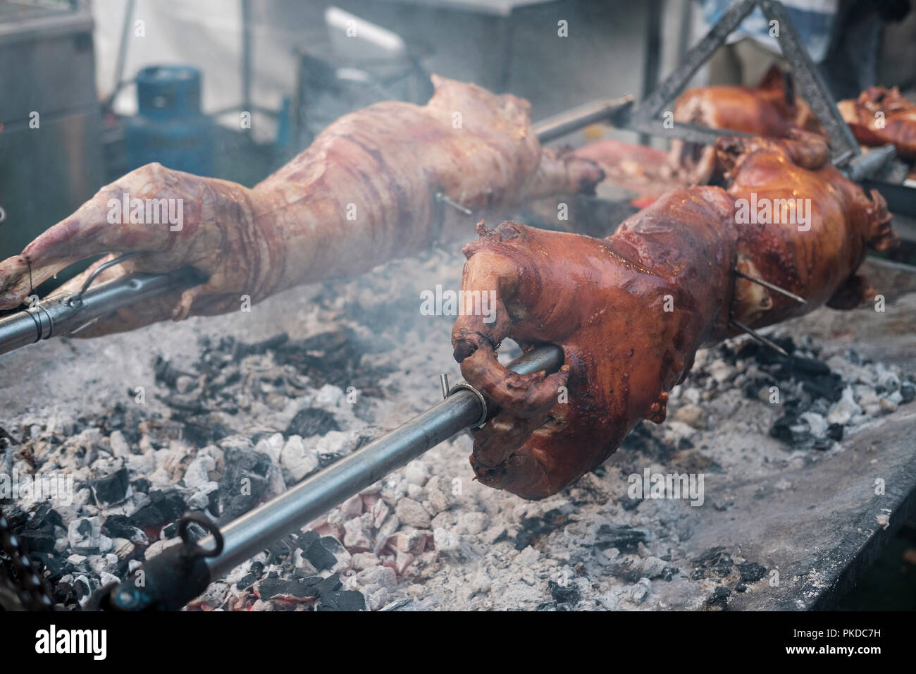 Whole pork and lamb roatsing on spit Stock Photo