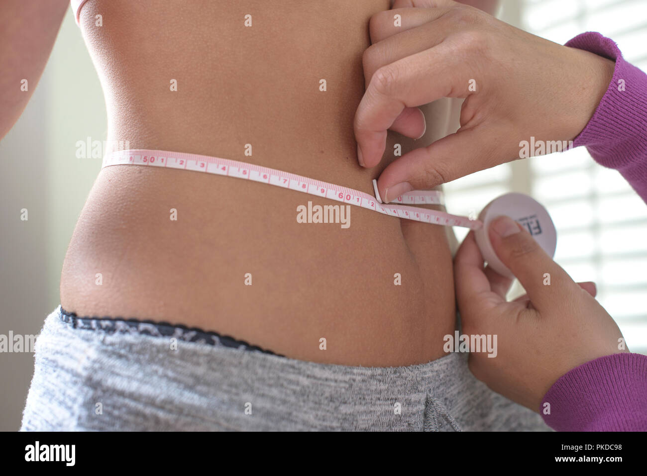 Waist measurements-slim teenage girl Stock Photo