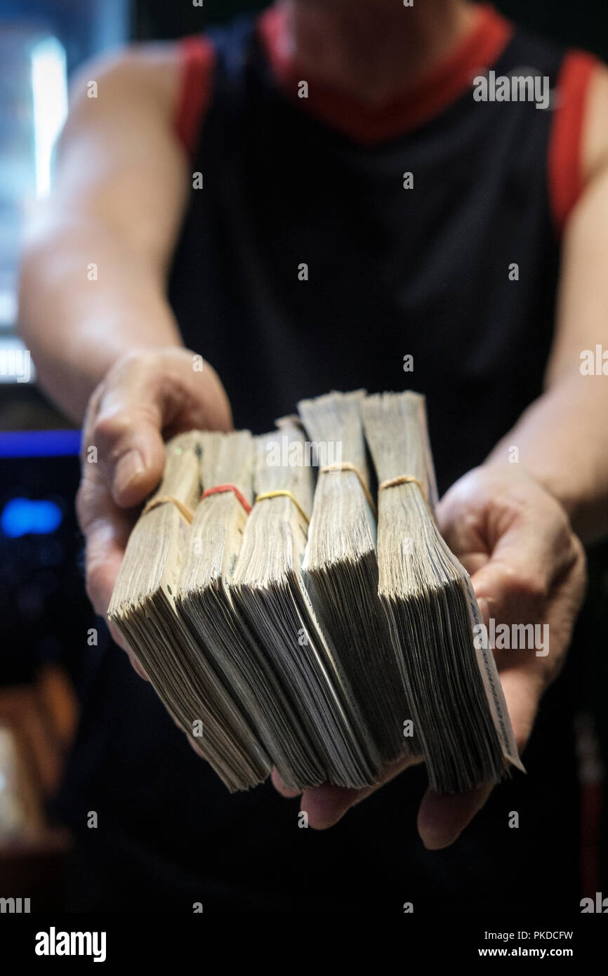 Person holding a stash of money.Corruption concept- cash,dirty money,money laundry Stock Photo