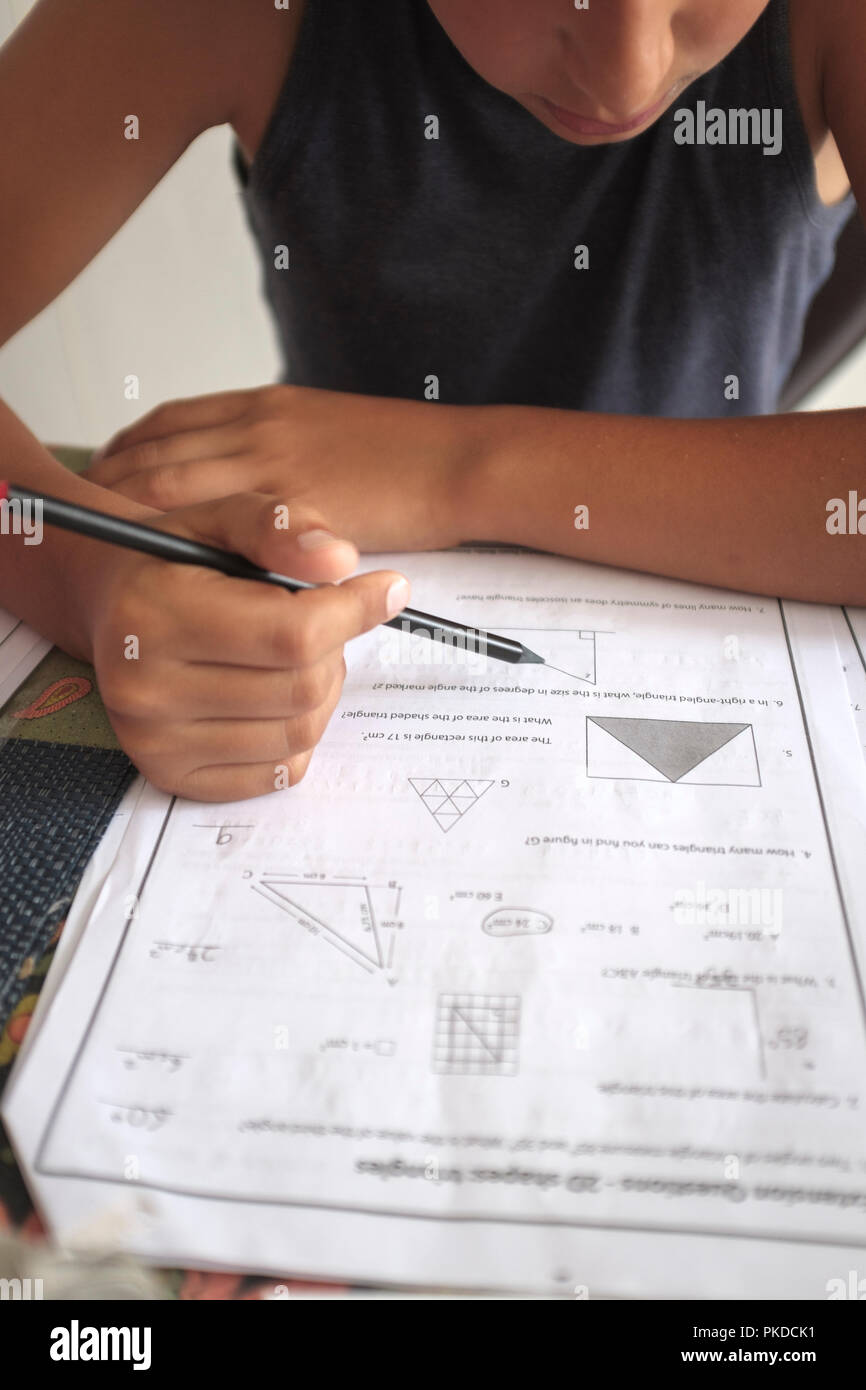 UK,Child -10 years old-works on maths homework Stock Photo