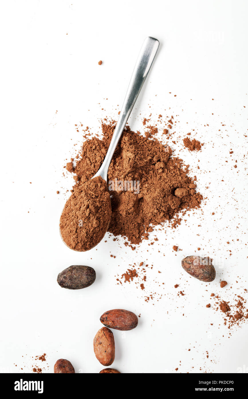 Spoon With Cocoa Powder and Cocoa Beans on the White Background Stock