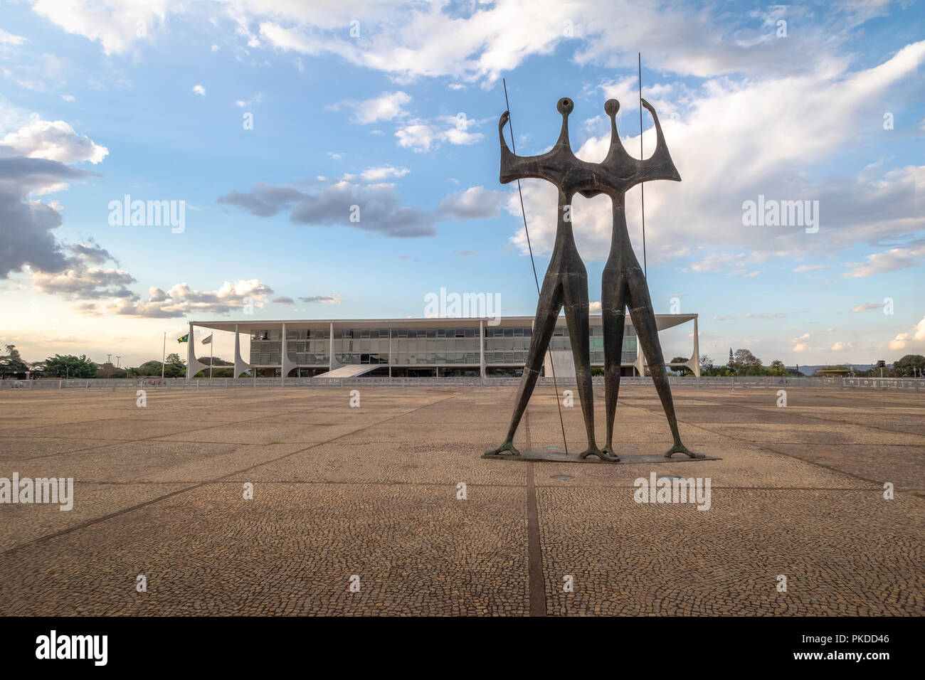 Candangos or Warriors Sculpture at Three Powers  Plaza with Planalto Palace on background - Brasilia, Distrito Federal, Brazil Stock Photo