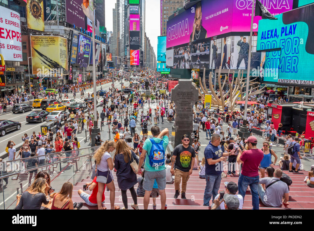 Visitors and tourists enjoying themselves at Times Square, 42nd Street in Manhattan, New York City. Stock Photo
