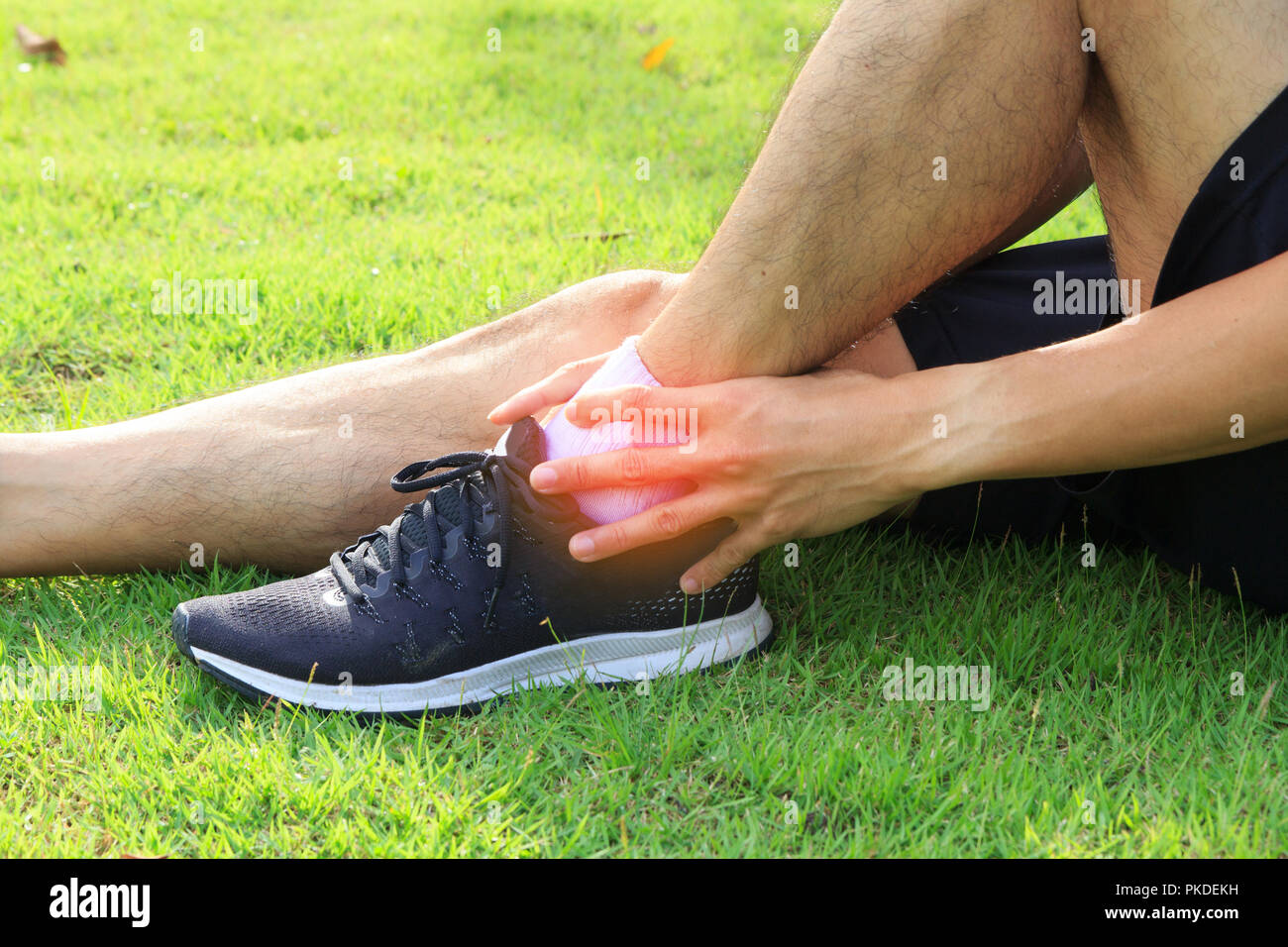 The man has hurt at the ankle / ankle hurt Stock Photo