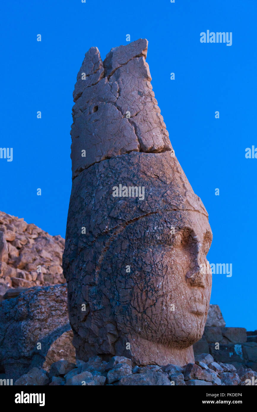 Statue of head at sunrise on the eastside of the mountain, Mt. Nemrut, Turkey Stock Photo