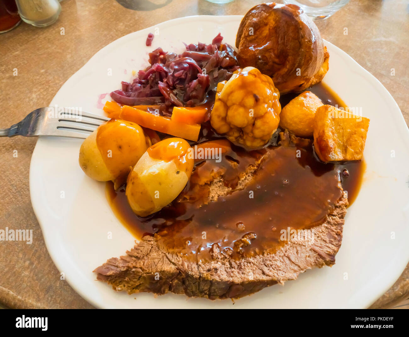 Sunday Lunch main course Roast Beef Yorkshire pudding vegetables and gravy at a farm cafÃ© Stock Photo