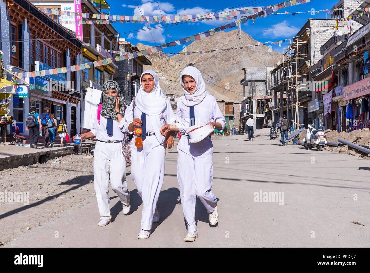 Leh, India - August 15, 2015: Three young muslim girls walking in a street of Leh, the capital of the Himalayan kingdom of Ladakh Stock Photo