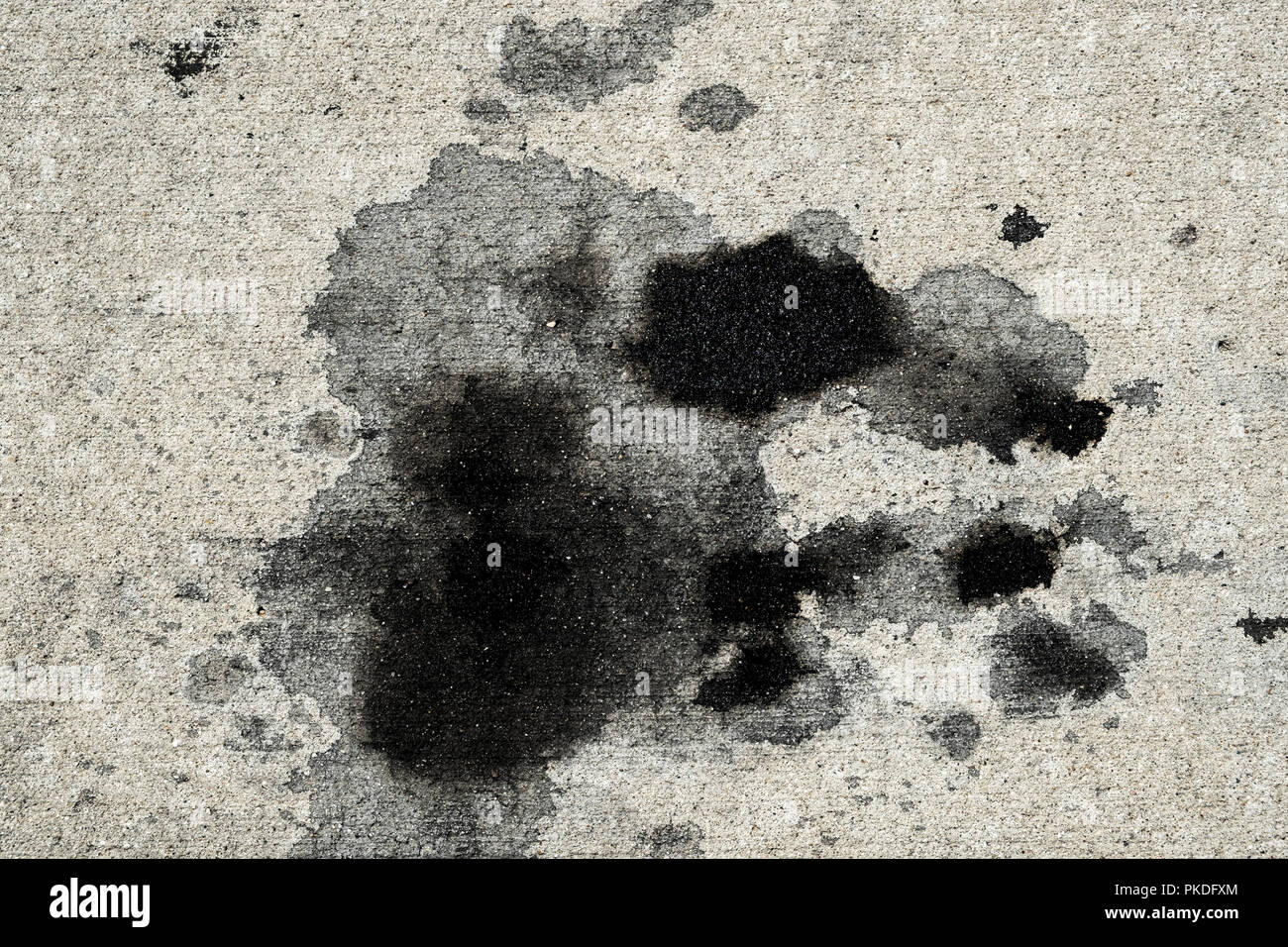 Motor oil stains on concrete pavement/texture background Stock Photo