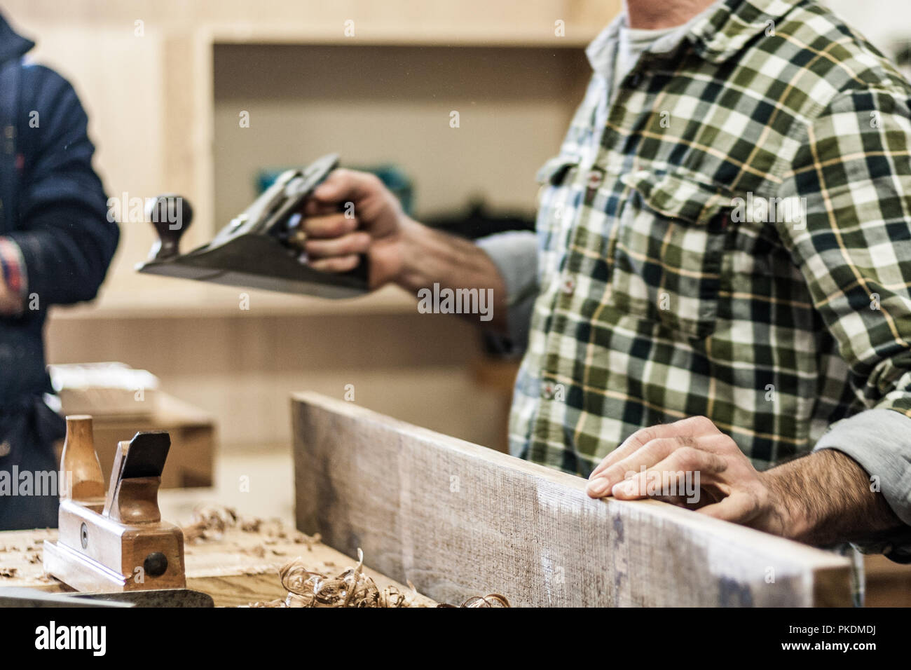 Professional woodshop store in Italy, focus on hands and working tools