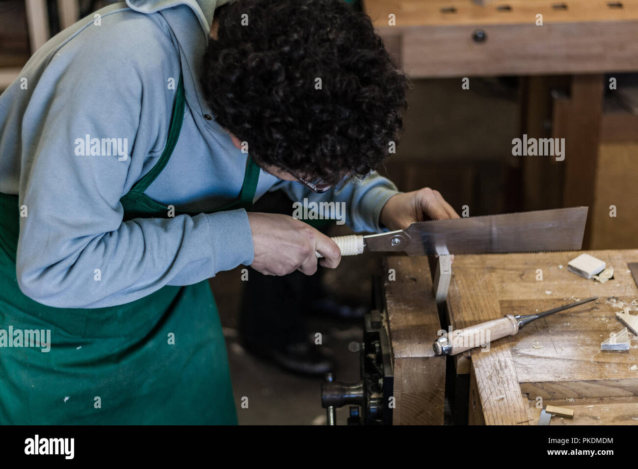 Professional woodshop store in Italy, focus on hands and working tools