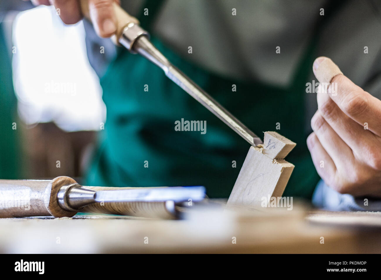 Professional woodshop store in Italy, focus on hands and working tools
