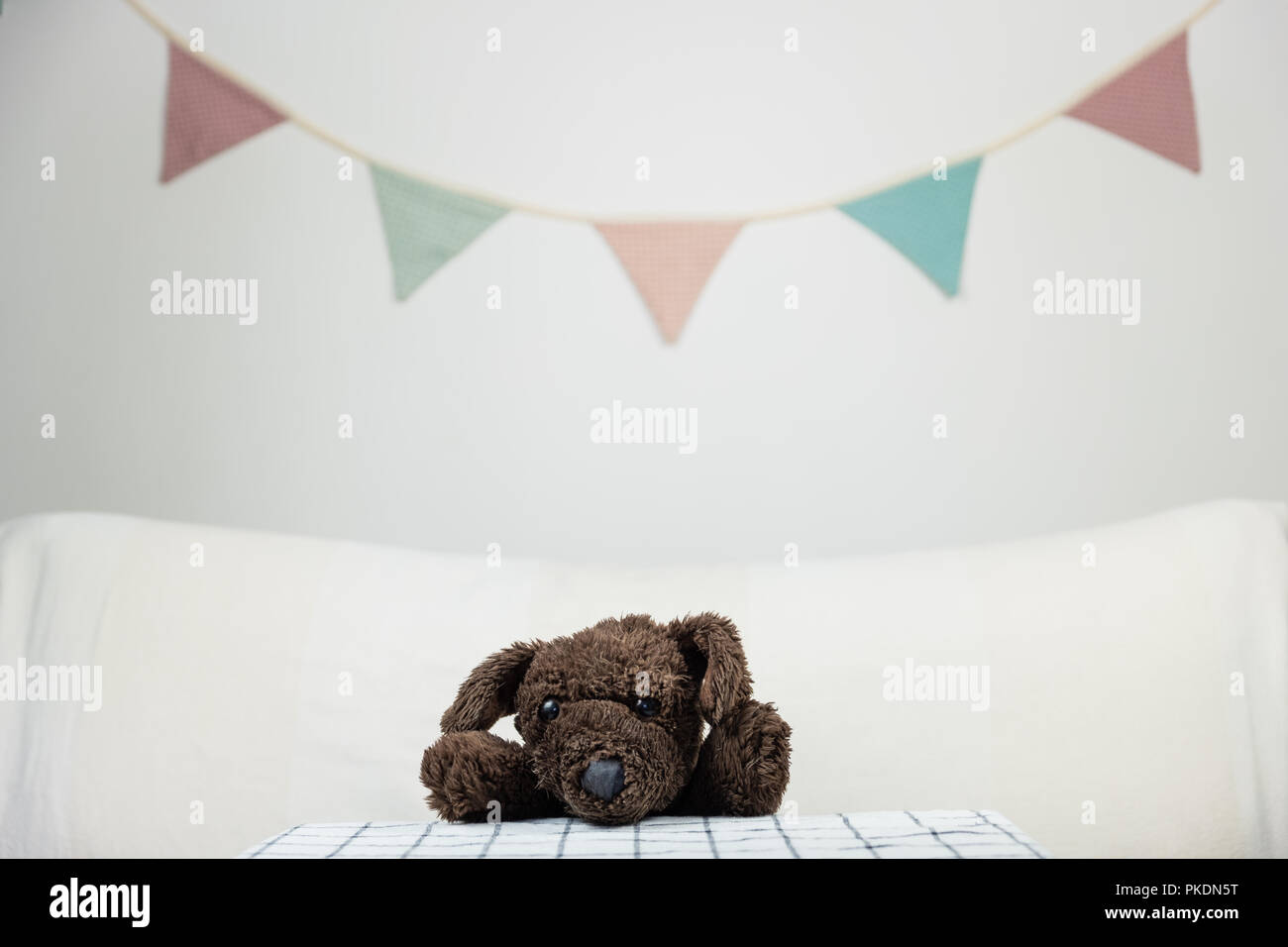Children party concept with fluffy toy dog at the table. Stock Photo
