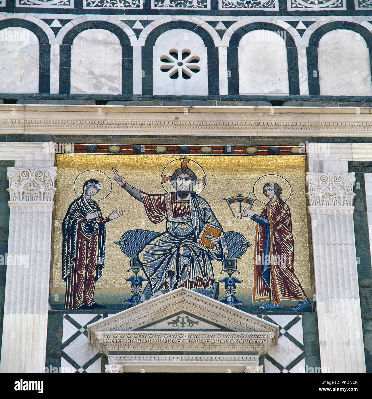 Italy. Florence. Basilica of San Miniato al Monte. Romanesque style. 11th century. Mosaic on the facade. Christ, the Virgin Mary and St. John. Tuscany. Stock Photo