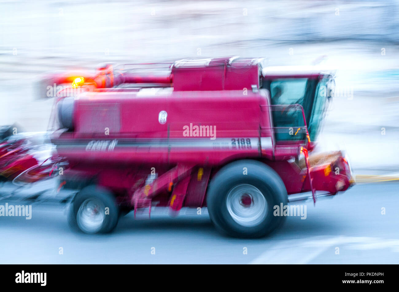 Movment blur of CASE combine harvester on public road - France Stock Photo  - Alamy