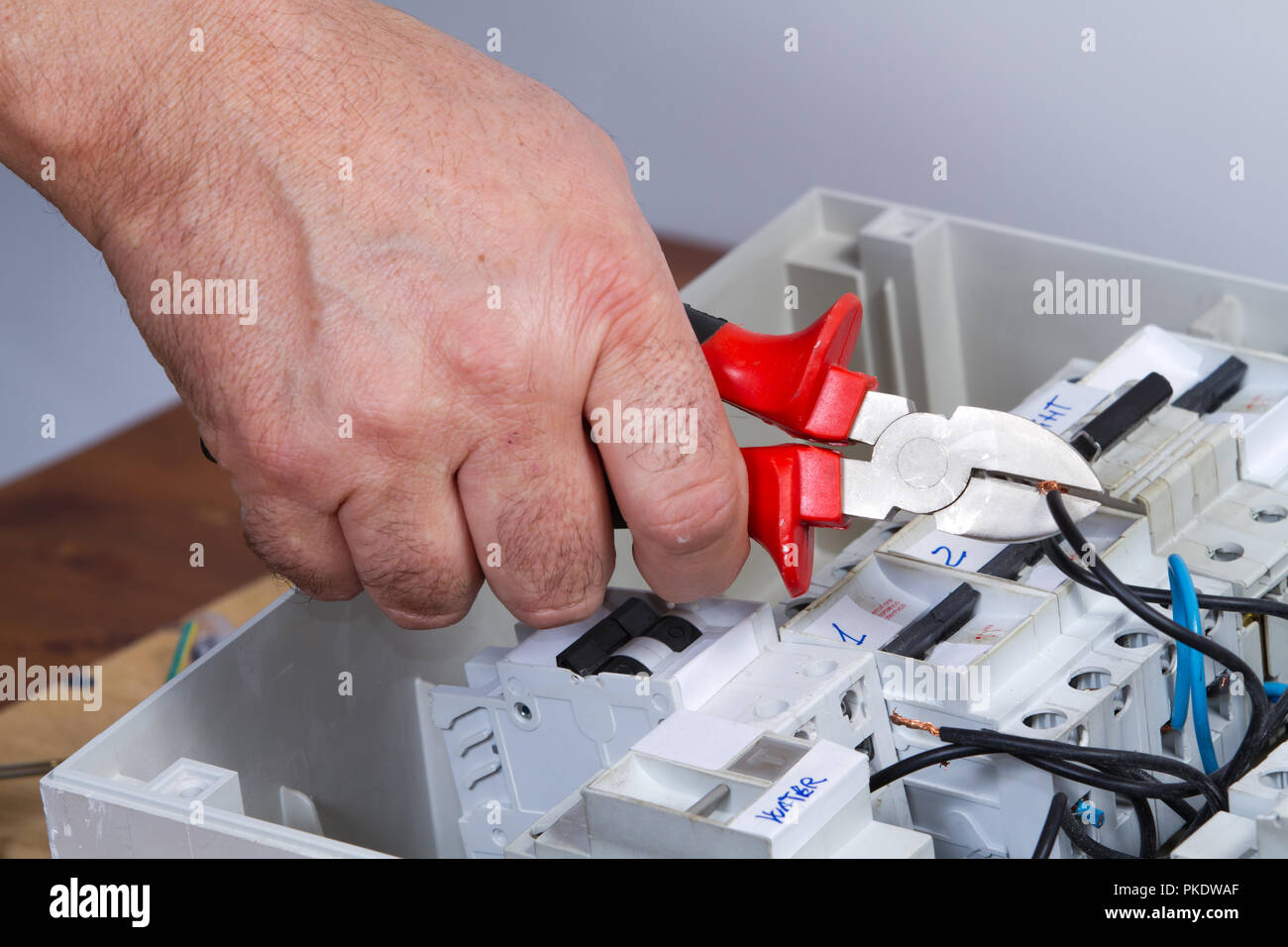 electrician at work with an appliance Stock Photo