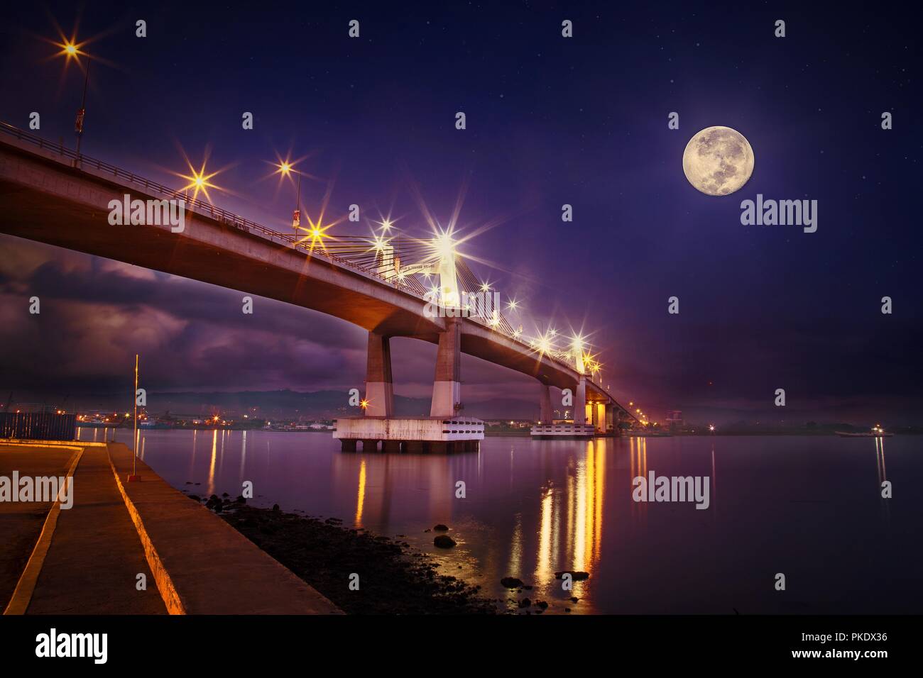 Mactan Bridge at full moon Night, super moon, reflection in water, cebu mactan strait, calm sea, view point, landmark Cebu, Stock Photo