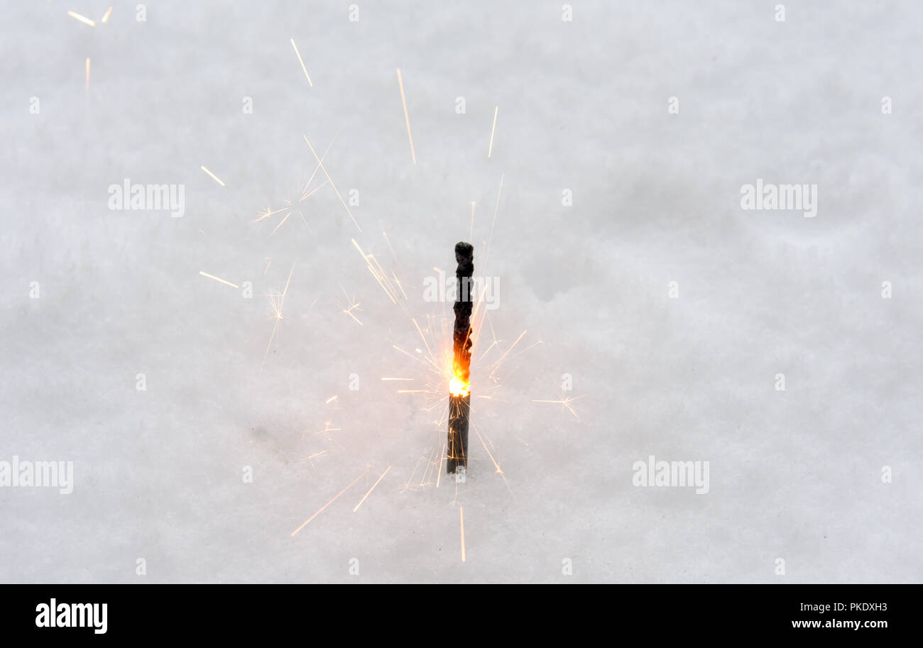 Burning glittering stick on the snow Stock Photo Alamy