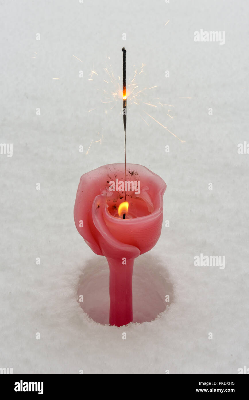 Burning glittering stick on a candle in the snow Stock Photo Alamy