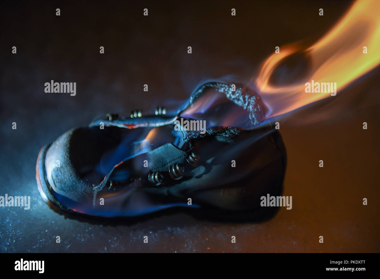 Burning old shoe at night on the Snow Stock Photo