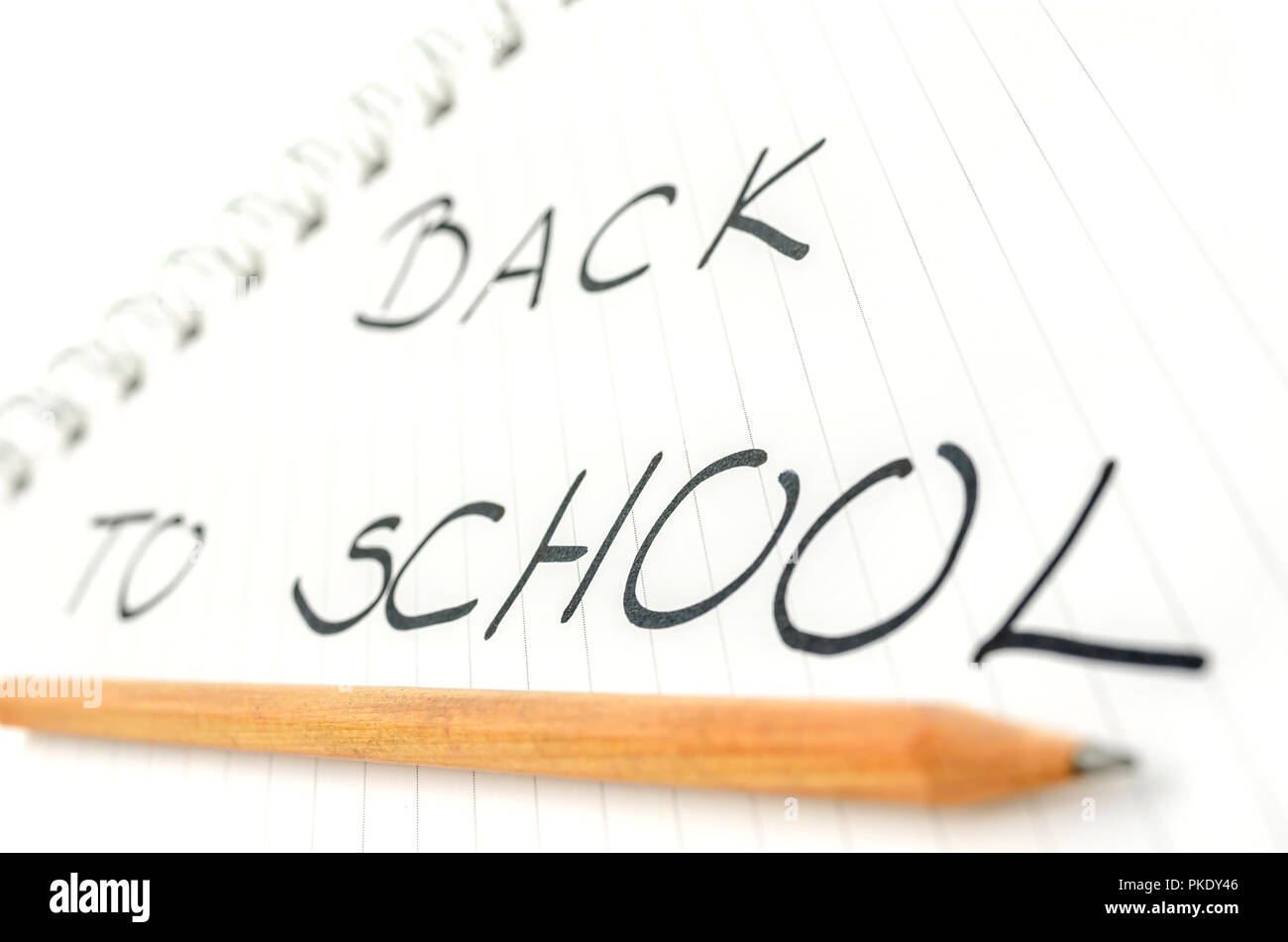 Back to school text written in spiral notebook underlined with pencil ...