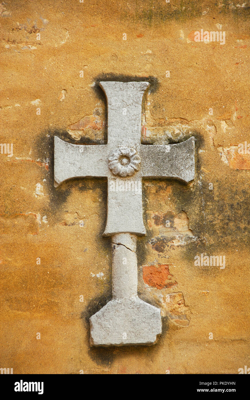 Holy Cross religious symbol with flower relief on a Venice wall Stock Photo