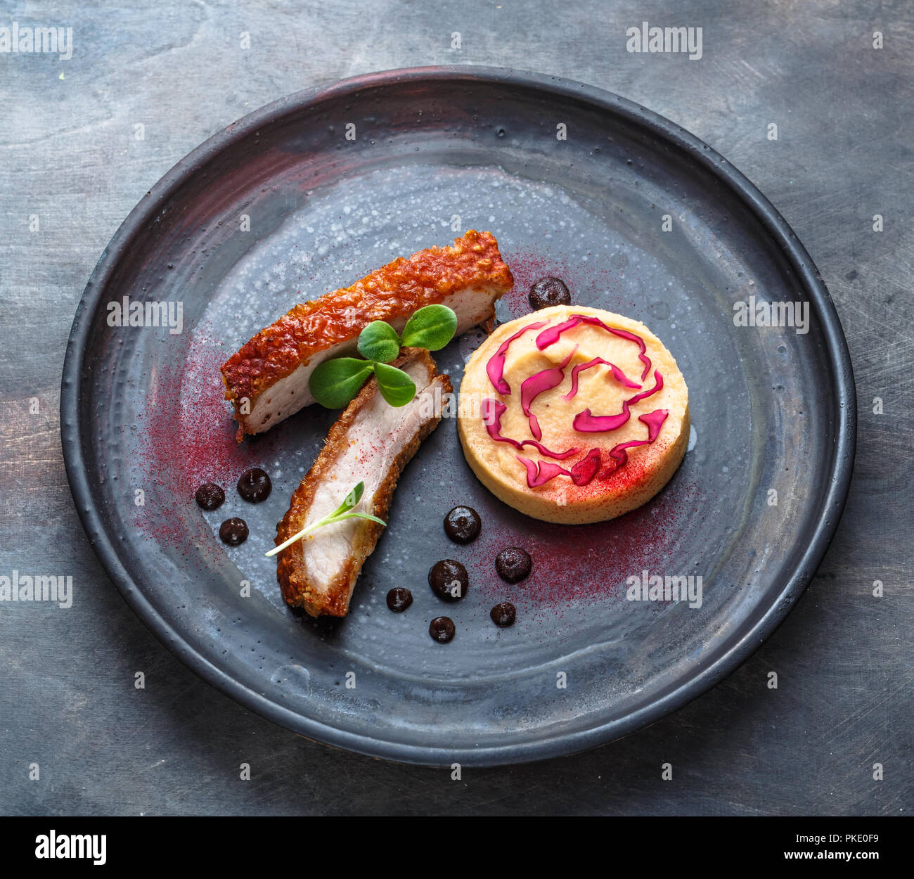 Crispy skin Pork Belly, with plum sauce, quince puree and pickled cabbage, restaurant dish Stock