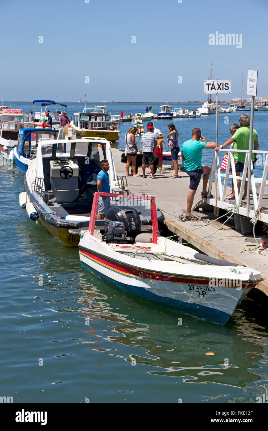 Harbour, Olhao, Algarve, Portugal. People getting off ferry Ferry to islands of Culatra-Farol, Armona, Ria Formosa Natural Park. Stock Photo