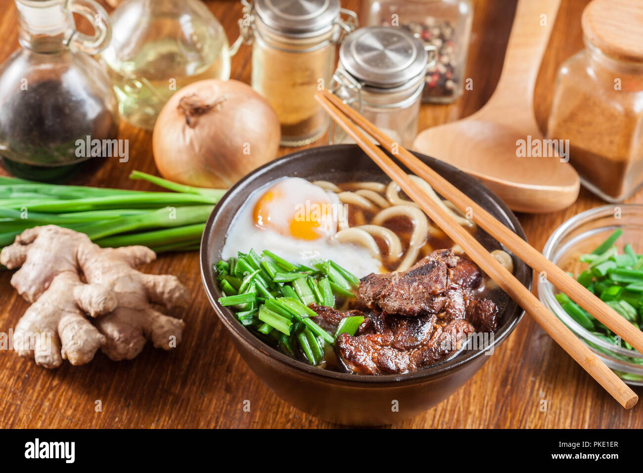 Japanese Udon noodles with beef, egg, green onion and soup in a brown bowl Stock Photo Alamy