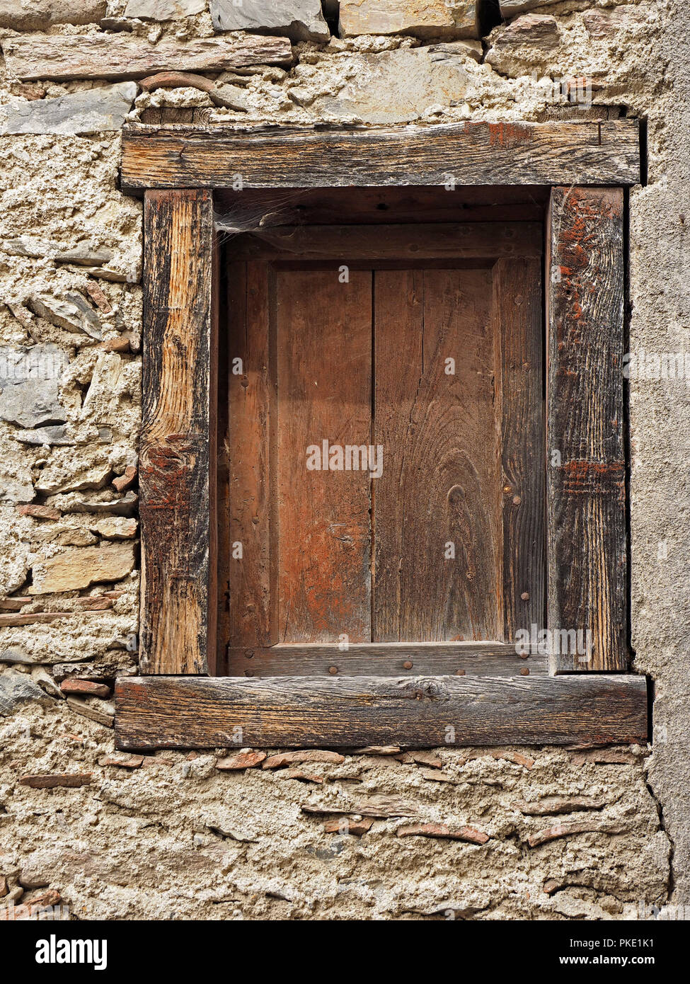 Rustic wooden shuttered window in neglected run down building in the ...