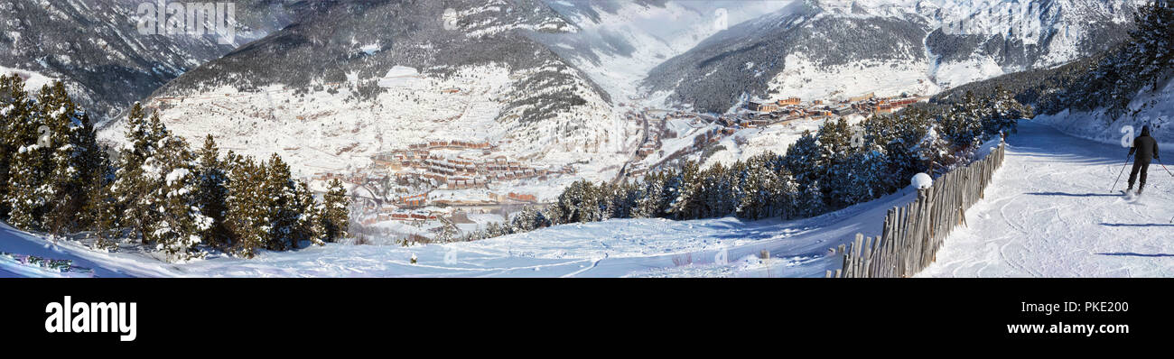 Panoramic view of Soldeu ski resort - El-Tarter in Andorra from a slope in sunny winter day. Buildings and the road in mountains are in the distance v Stock Photo