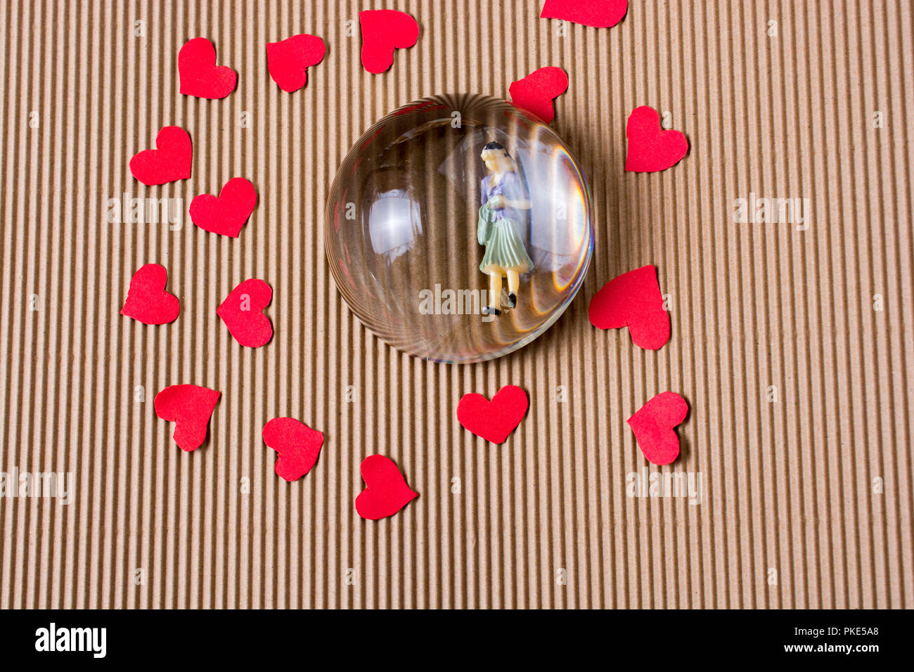 Woman figurine and Love concept with red paper hearts Stock Photo - Alamy