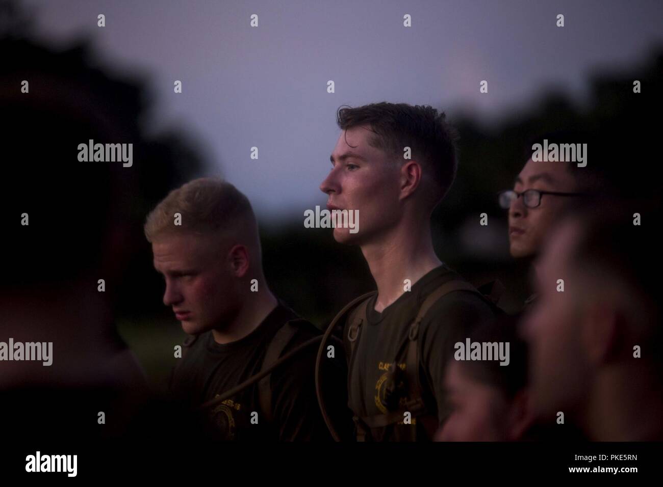 Cpl. William Baker, center, an ammunition technician with Headquarters Company, Headquarters Regiment, 3rd Marine Logistics Group, listens as Master Sgt. Eric C. Hernandez speaks to the Marines in Corporals Course class 576-18 July 25, 2018 at Hacksaw Ridge, Okinawa, Japan. Hernandez, a guest speaker for the class, is the operations chief of Communications Company, HQ Reg., 3rd MLG. Baker is a native of Bowling Green, Kentucky. Hernandez is a native of Forest Hills, New York. Stock Photo