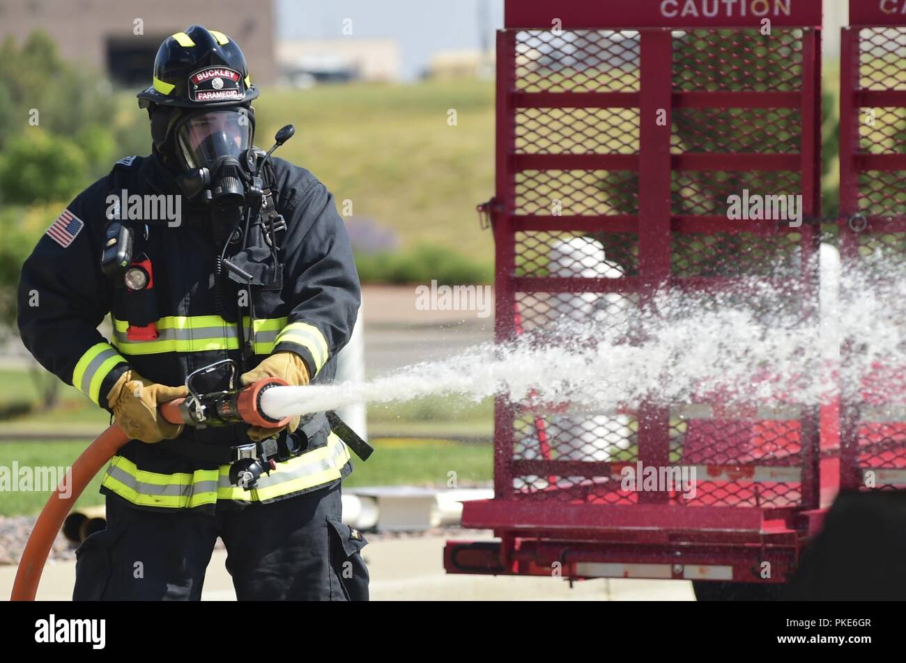 Josh Thomas, 460th Civil Engineer Squadron firefighter, extinguishes a car fire during Exercise Panther View 18-3 July 25, 2018, on Buckley Air Force Base, Colorado. Exercises are held quarterly to test a base’s ability to respond and recover from various incidents. Stock Photo