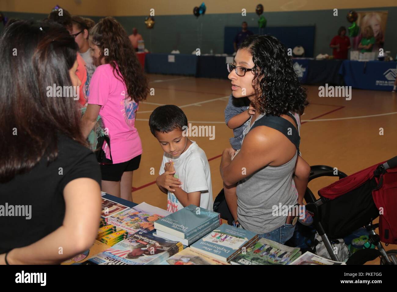 FORT BENNING, Ga. (July 27, 2018) – To accommodate service members with school-age children, Fort Benning Family and Morale, Welfare and Recreation (MWR) held two back-to-school events July 26 and July 27. The main event was child and Youth Services’ Back-2-School Bash July 27, where parents and their school-age children lined up around the block to the Youth Services Campus to pick up free school supplies and meet several of the on-post services available to them. The Exceptional Family Member Program (EFMP), Army Community Service, MWR, held a similar but smaller back-to-school luau at Breez Stock Photo