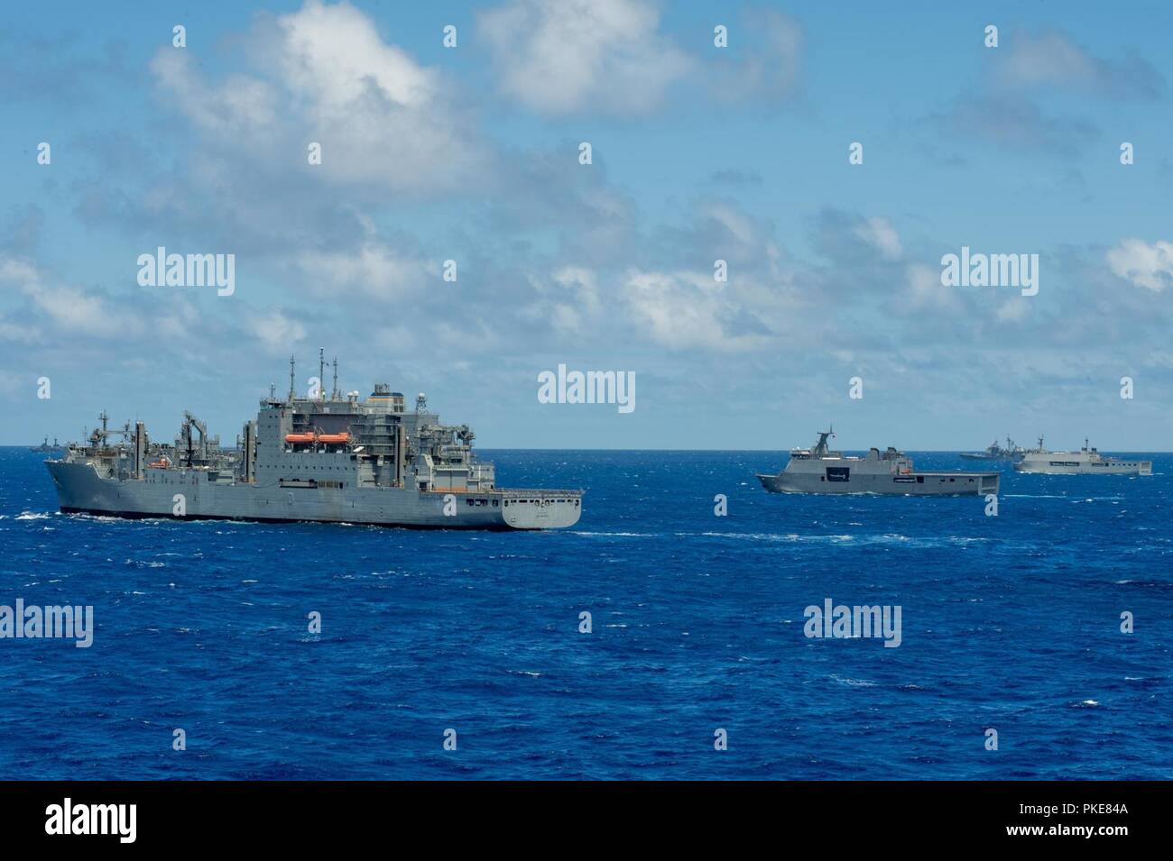 PACIFIC OCEAN (July 26, 2018) Military Sealift Command (MSC) auxiliary dry cargo and ammunition ship USNS Carl Brashear (T-AKE 7), Philippine Navy landing platform dock BRP Davao Del Sur (LD 602), Republic of Indonesia Navy landing dock ship KRI Makassar (590) and guided-missile cruiser USS Lake Erie (CG 70) steam in formation during Rim of the Pacific (RIMPAC) photo exercise, July 26. Twenty-five nations, 46 ships, five submarines, about 200 aircraft, and 25,000 personnel are participating in RIMPAC from June 27 to Aug. 2 in and around the Hawaiian Islands and Southern California. The world’s Stock Photo
