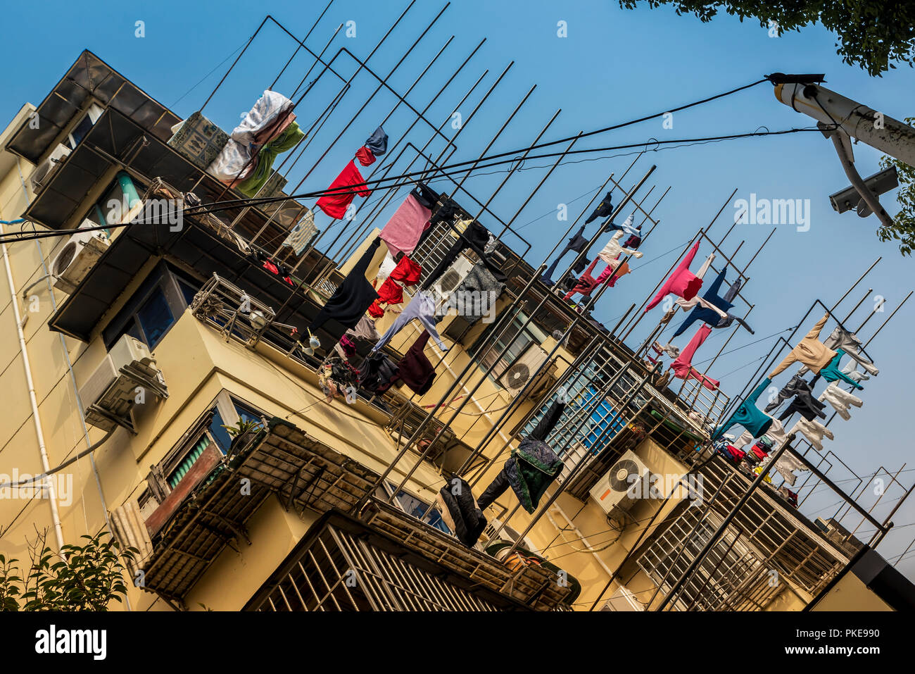 Low angle view of clothing hanging to dry outside an apartment building, Qibao Old Town, Minhang District; Shanghai, China Stock Photo