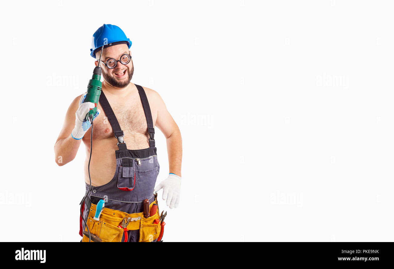 The fat funny man builder with a drill. Stock Photo