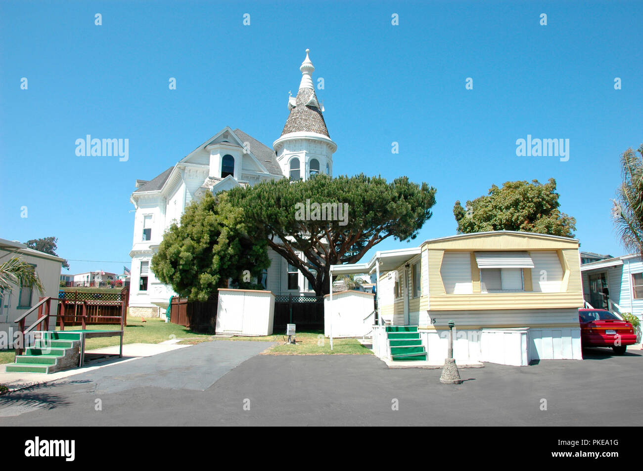 Old Victorian home surrounded by mobile homes in Oceano California at