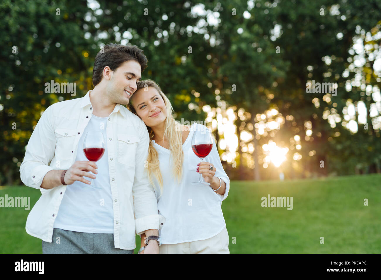 Joyful happy couple standing together in the field Stock Photo