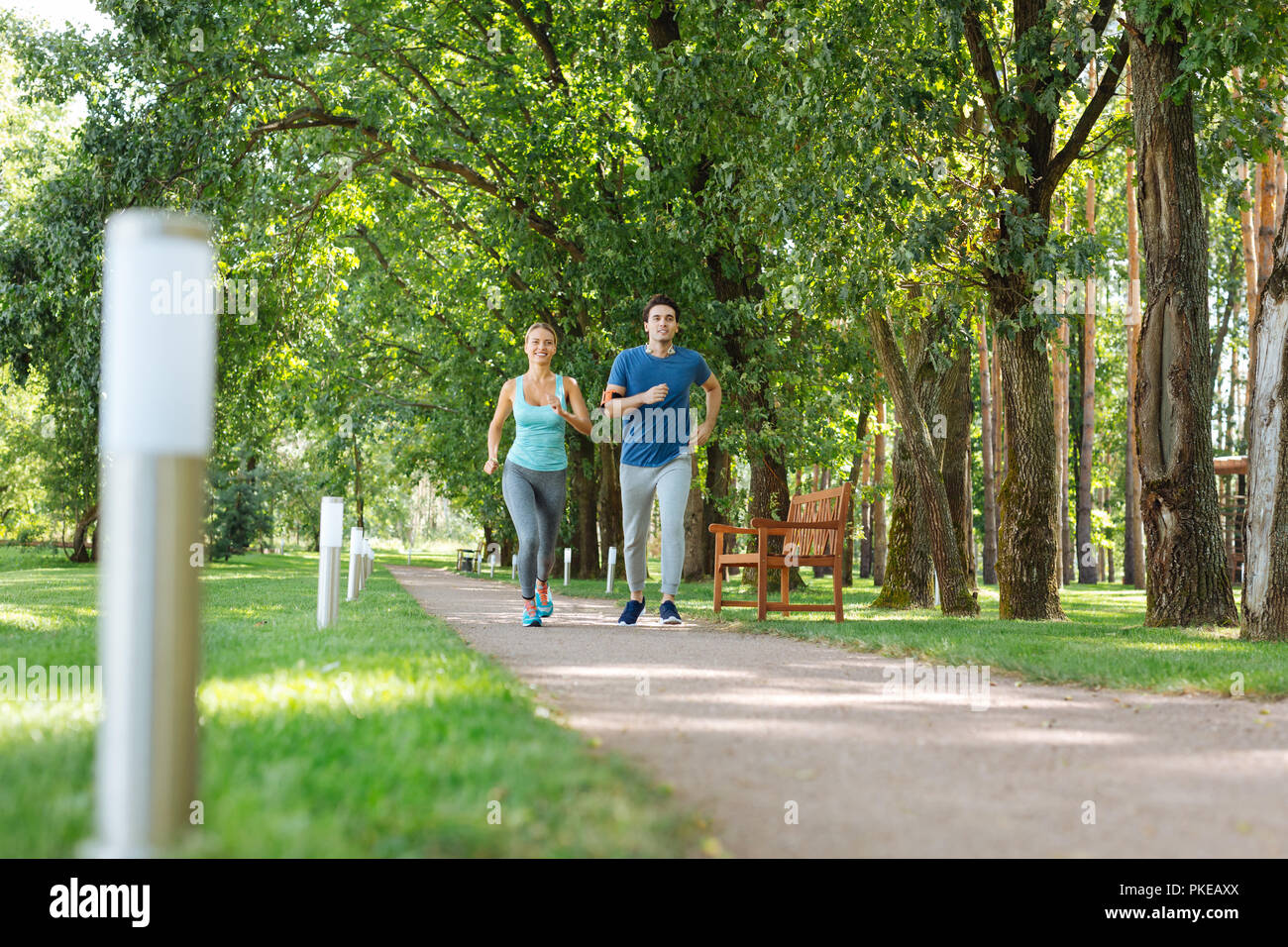 Happy positive couple deciding who is faster Stock Photo