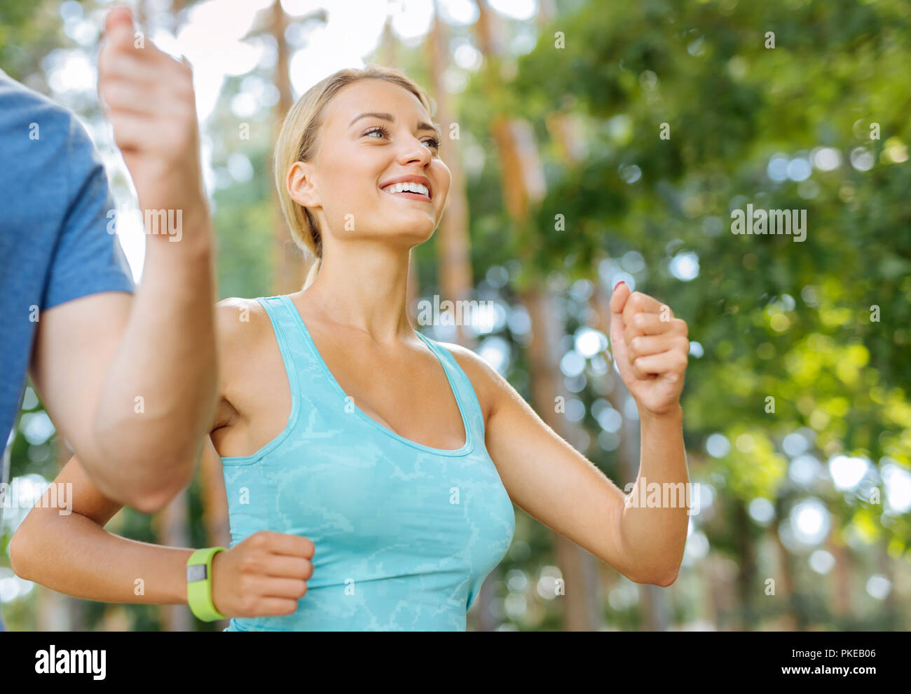 Delighted happy women looking at her friend while running Stock Photo