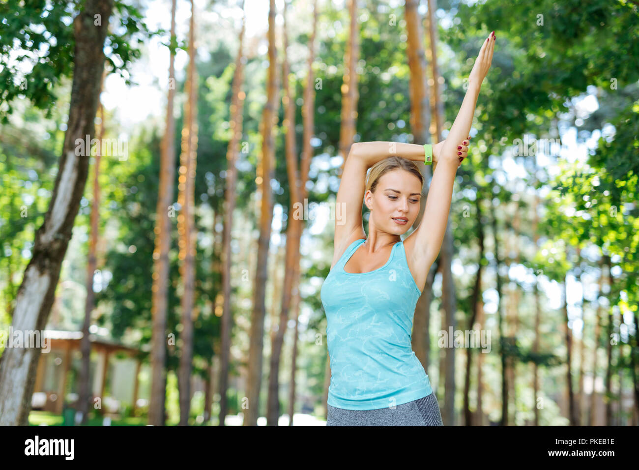 Pleasant nice young woman practicing yoga outdoors Stock Photo