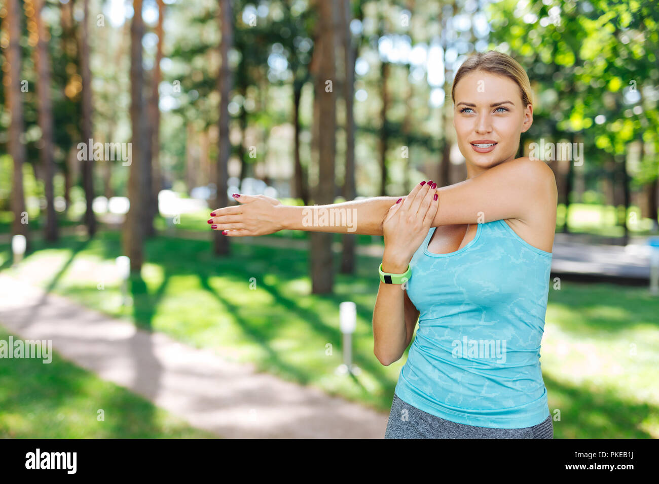 Nice fit young woman holding her hand Stock Photo