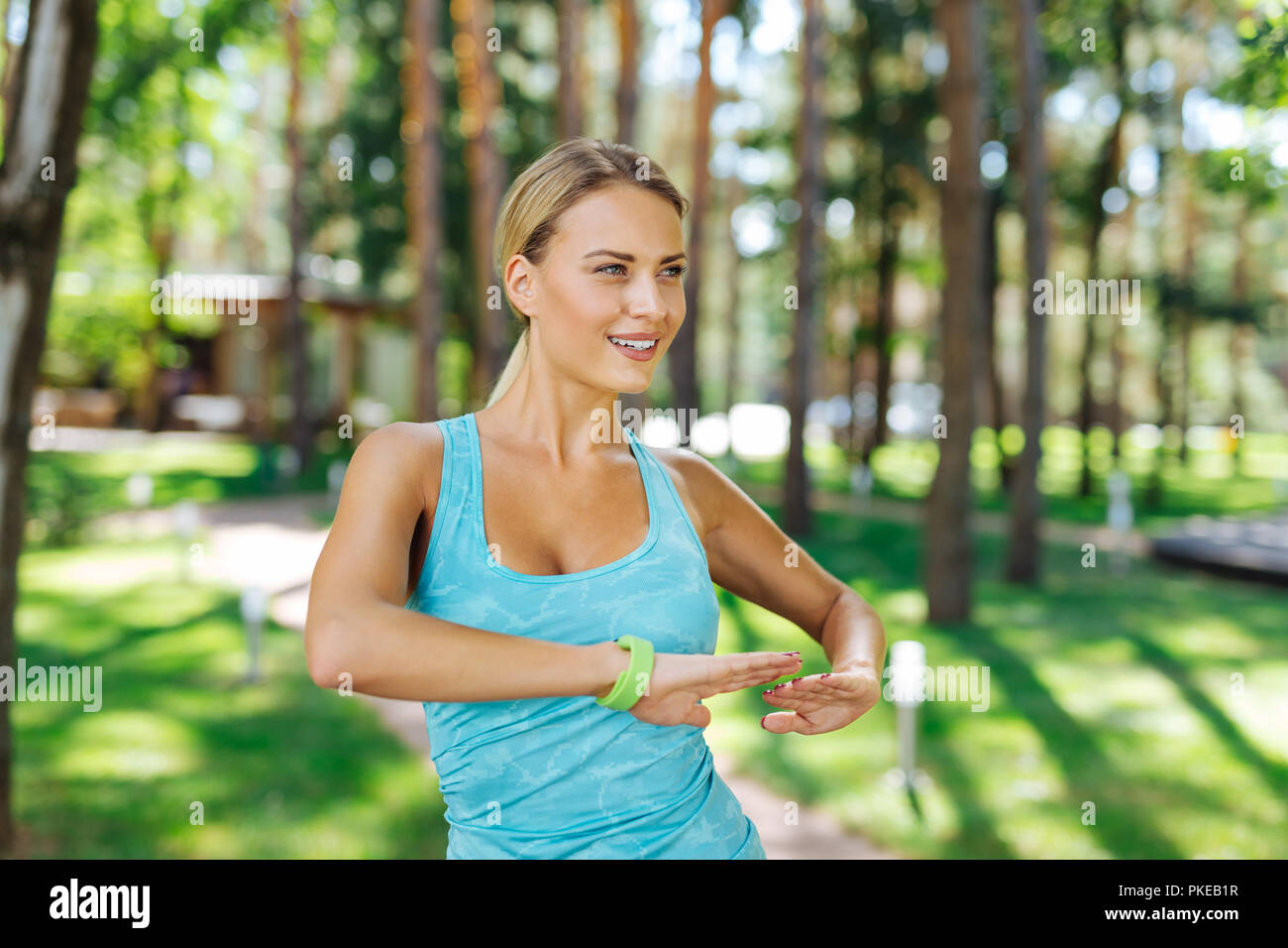 Delighted joyful fit woman enjoying doing exercises Stock Photo
