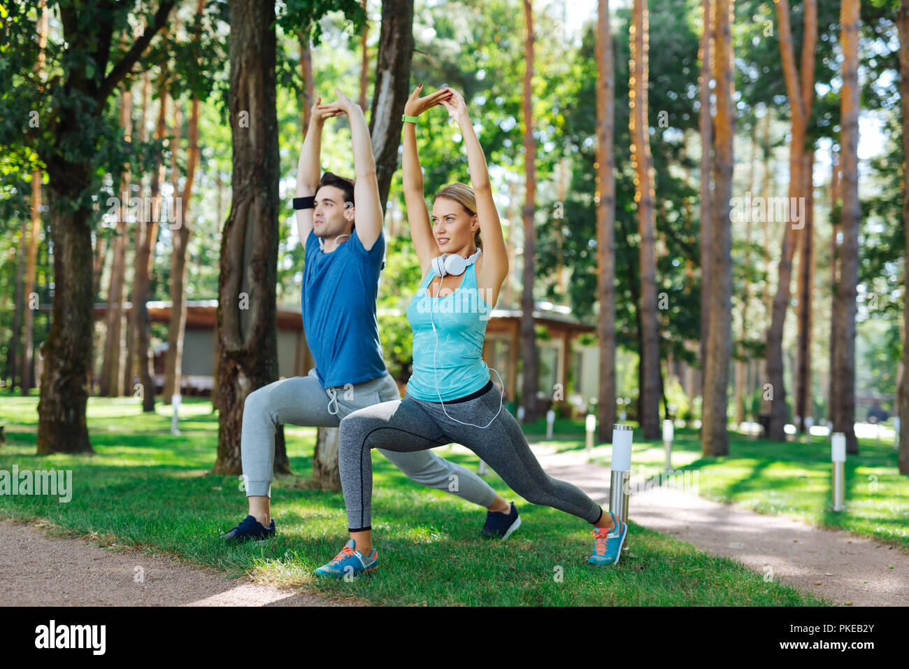 Positive nice people exercising in the park Stock Photo