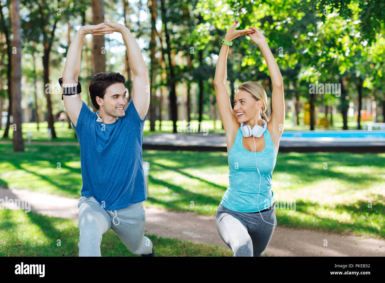 Joyful positive couple holding their hands up Stock Photo