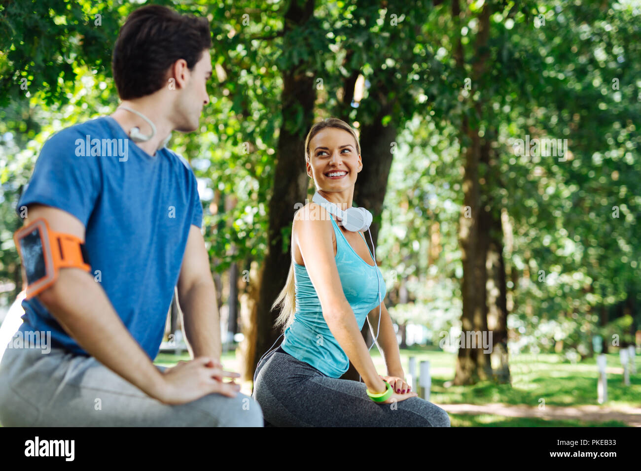 Cheerful sportive fit woman smiling to her boyfriend Stock Photo